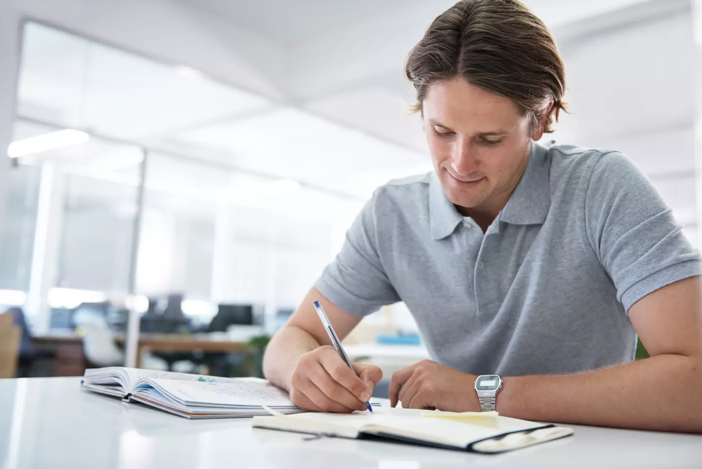 A motivated individual engaging with an aptitude test preparation guide on their desk