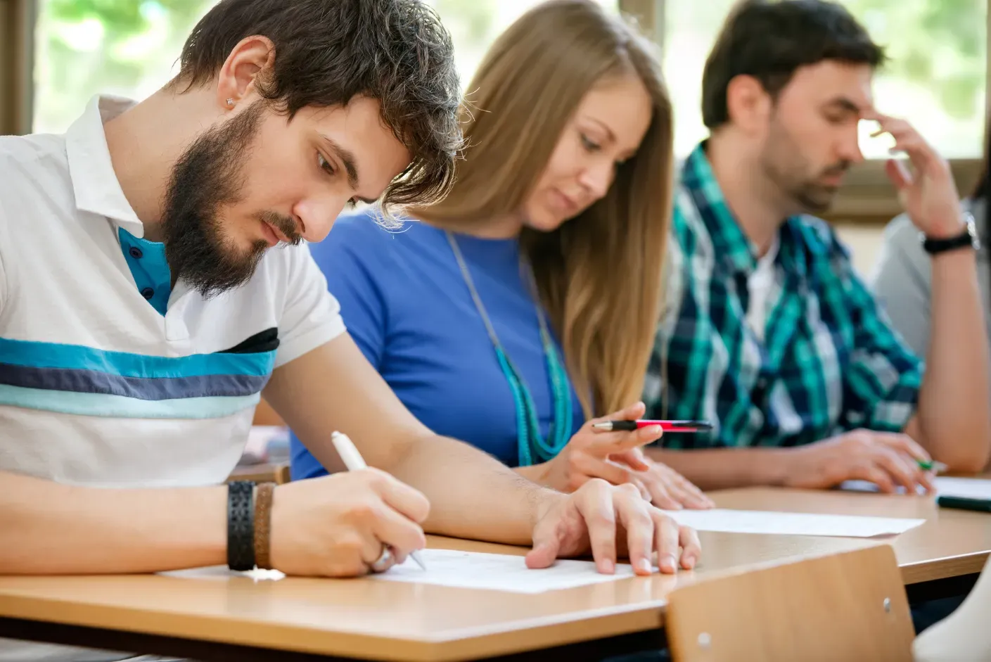 A focused student preparing for the GCSE Test English with textbooks and notes